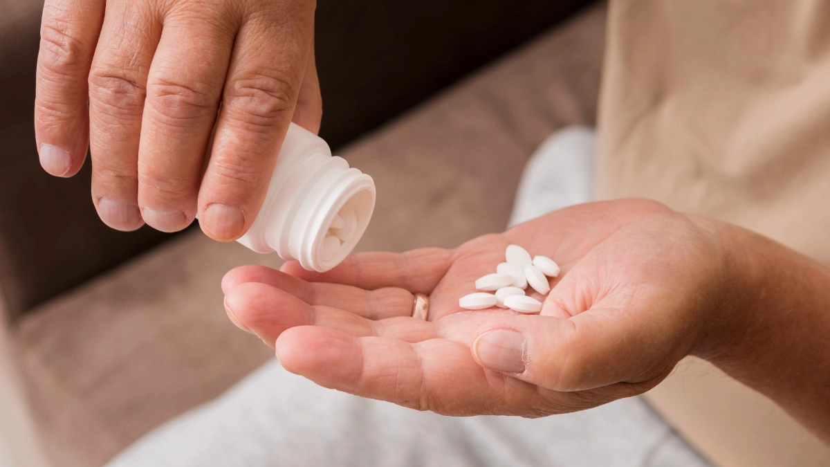 Person pouring pills in their hand