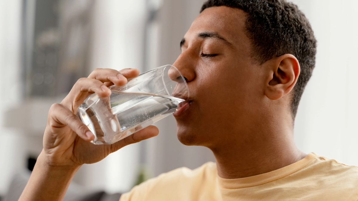 A man drinking glass of water